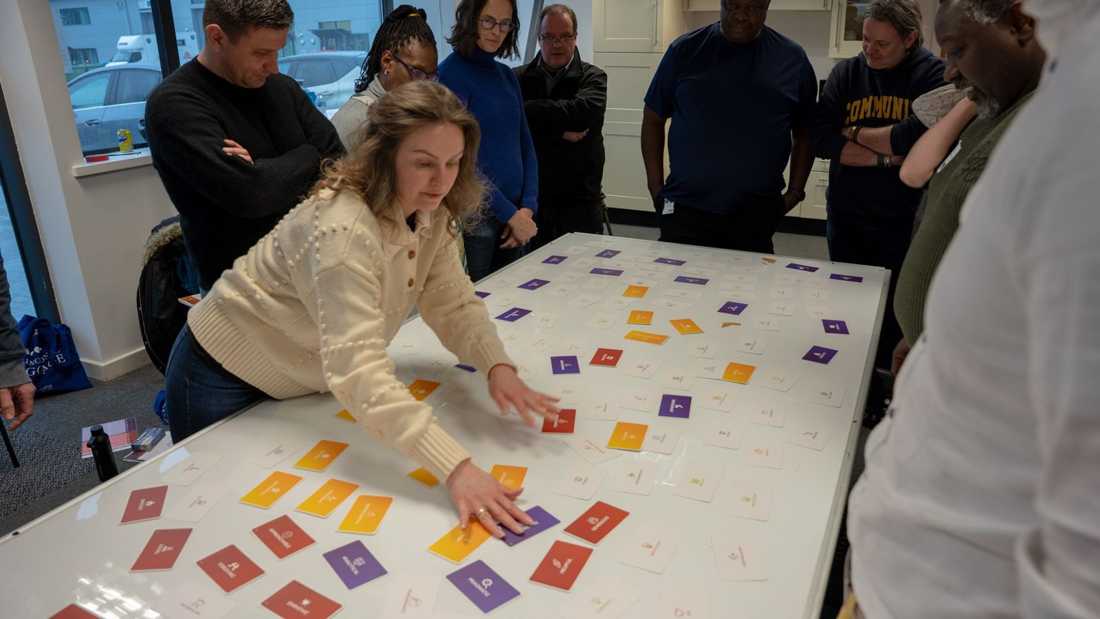Participants sort strength cards on a table, London