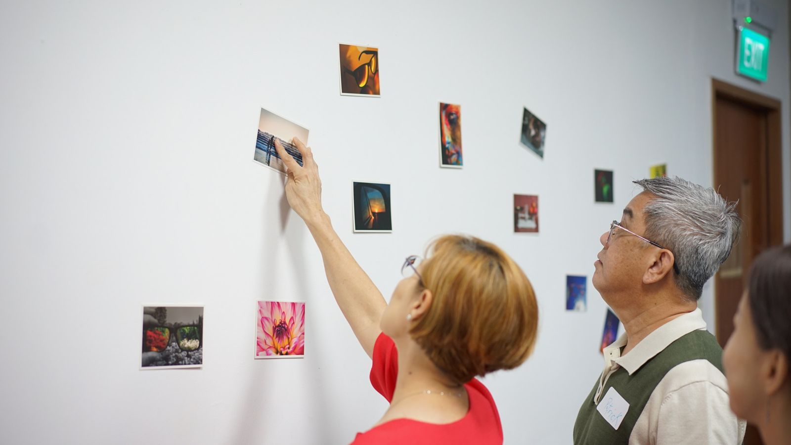 Participants pin picture cards to the wall, Singapore